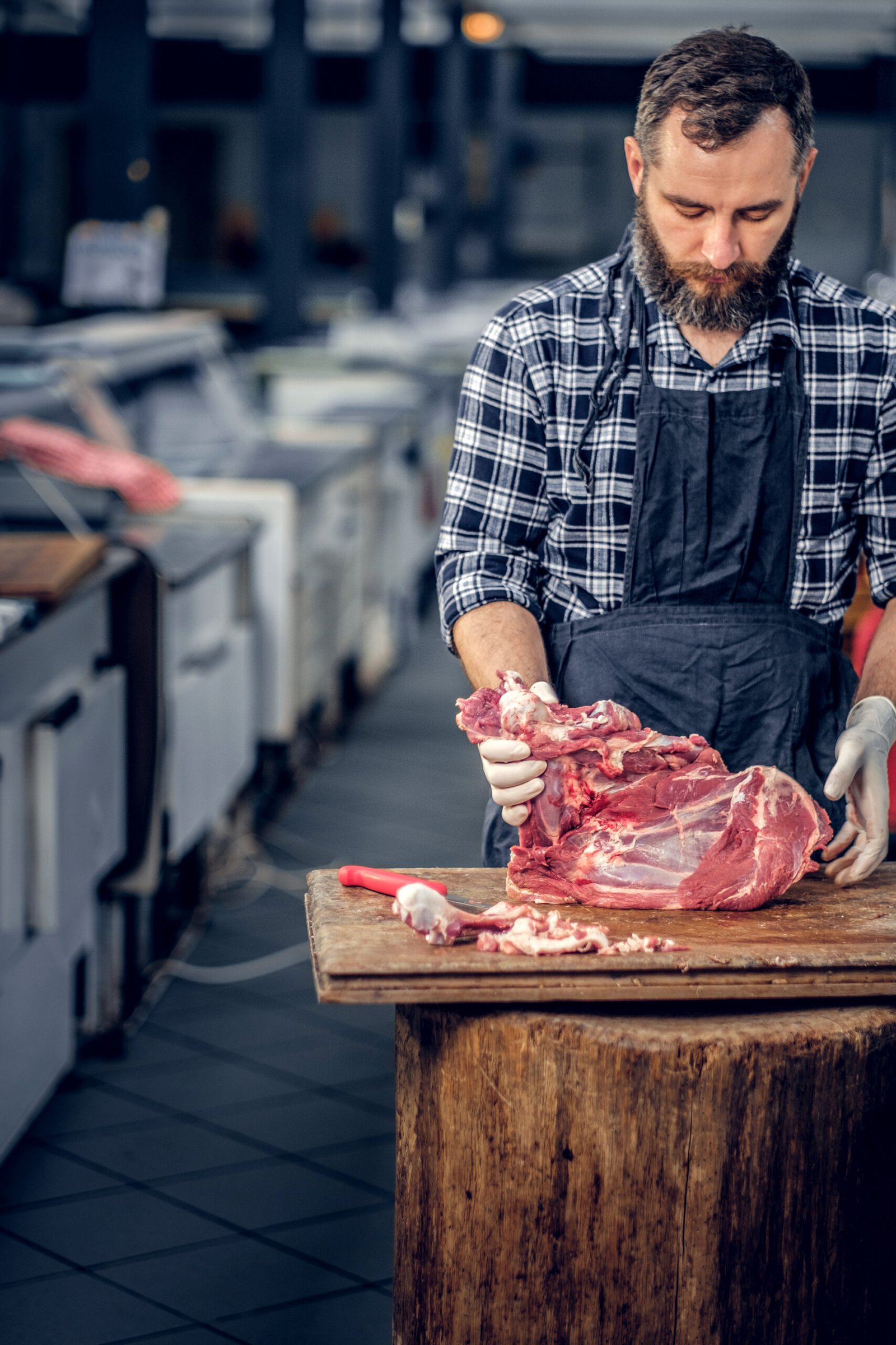 bearded butcher cut fresh bacon meat.